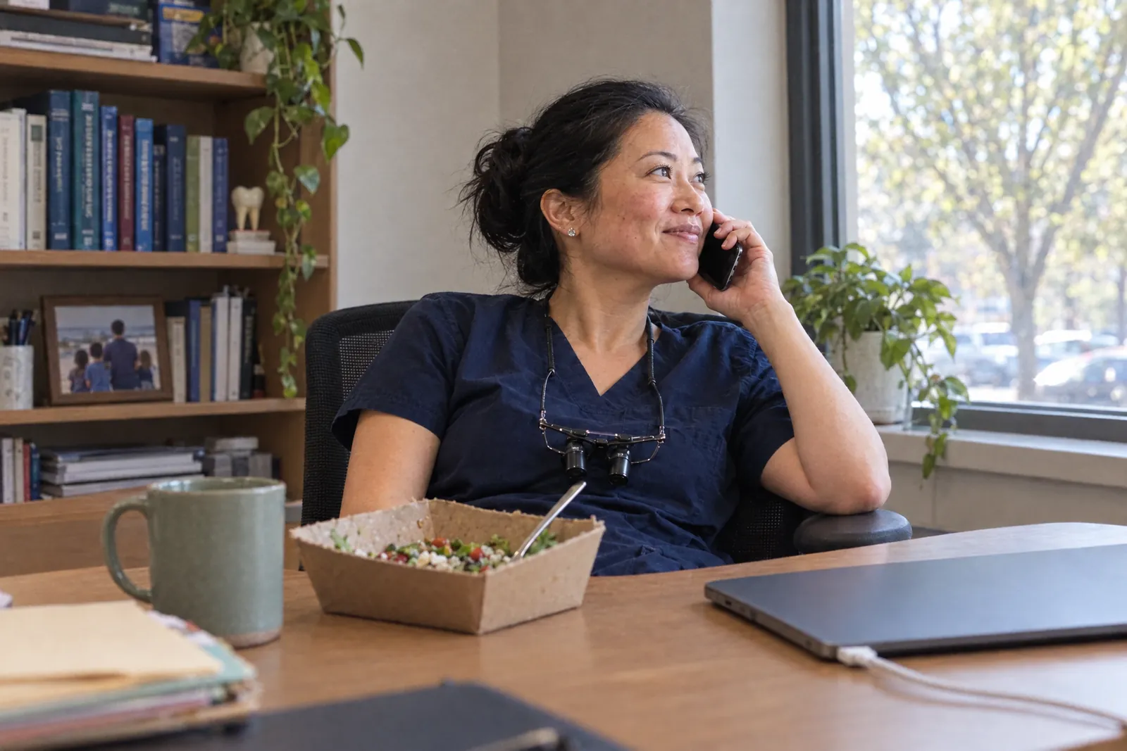 A dentist in her office at lunch, listening on the phone