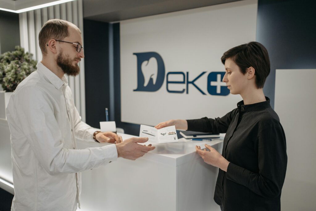 AI medical receptionist managing appointments at a dental clinic front desk.