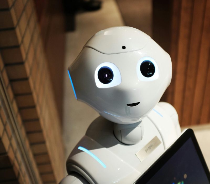 AI receptionist assisting a patient at a clinic front desk, illustrating how AI receptionists are changing clinics.- automotive answering service