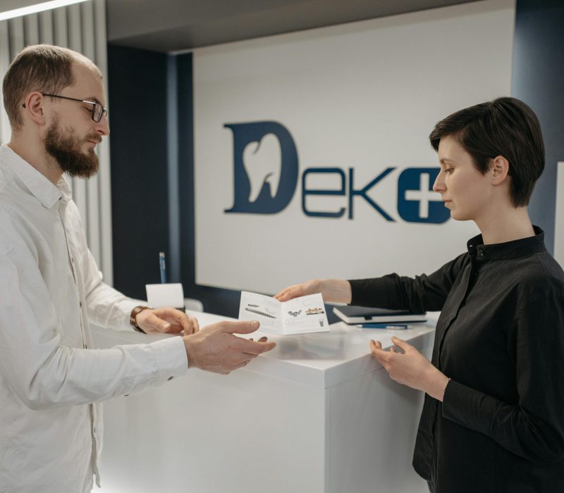 AI medical receptionist managing appointments at a dental clinic front desk.