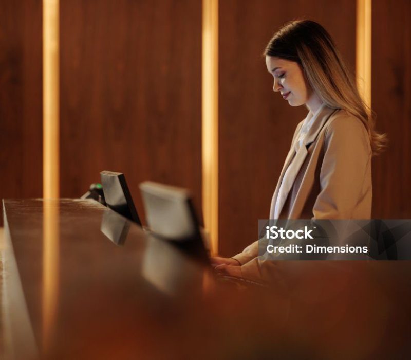 Contemporary office front desk without receptionist, featuring digital check-in and virtual assistant technology.
